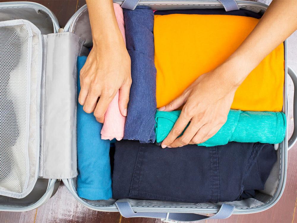 Packing luggage securely for intercity shipping in India with protective wrapping and suitcase lock